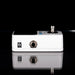 White guitar effects pedal with black background