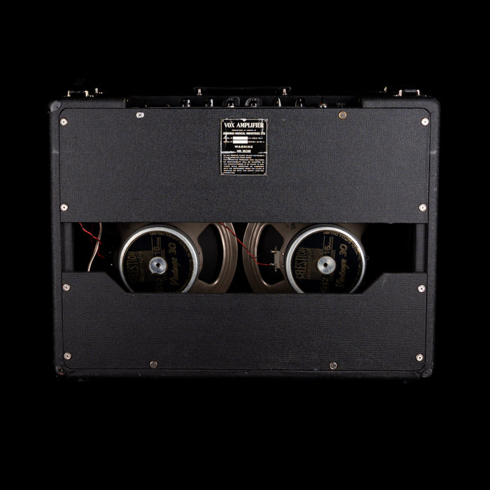 Back view of a guitar amplifier with visible wiring and VOX branding.