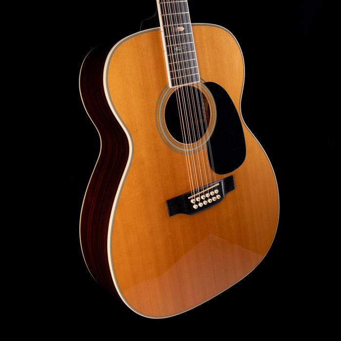 Acoustic guitar with a wooden finish on a black background
