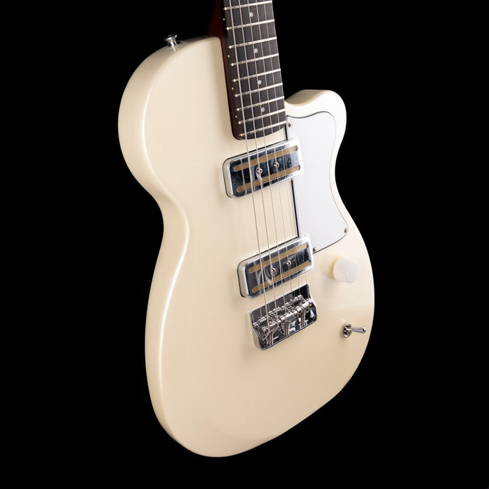 White electric guitar on a black background