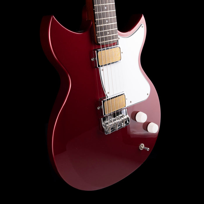 Red electric guitar on a black background
