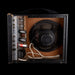 Vintage amplifier with speaker and control panel on a black background
