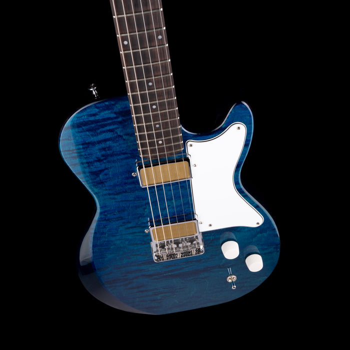 Blue electric guitar with a white pickguard on a black background