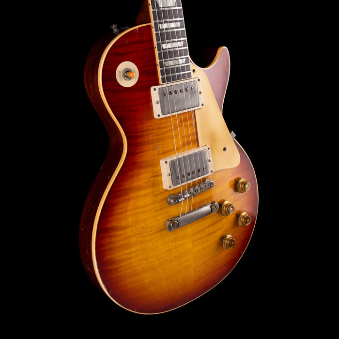 Electric guitar with a sunburst finish on a black background