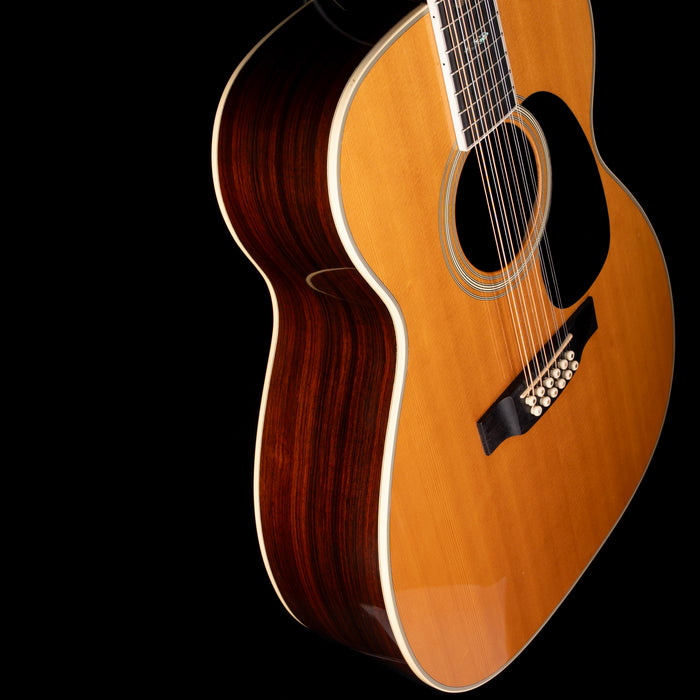 Acoustic guitar with a dark brown finish on a black background