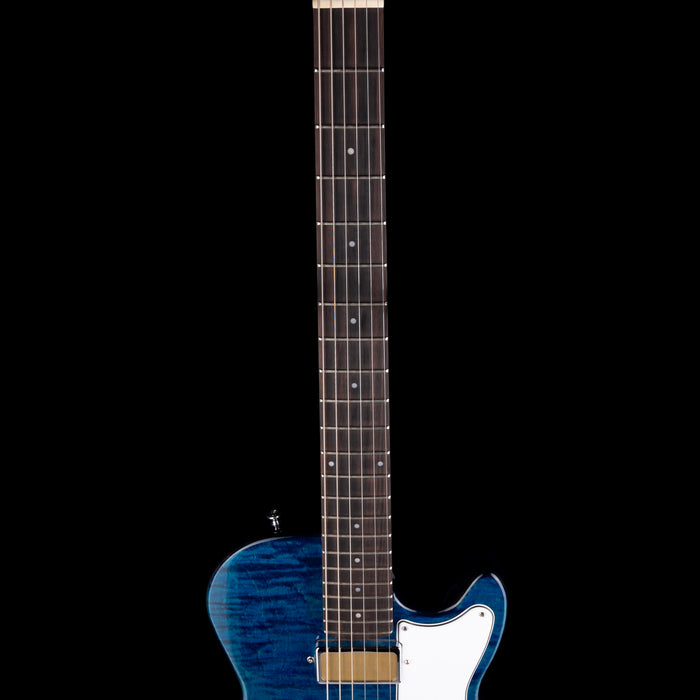 Blue electric guitar with a white pickguard on a black background