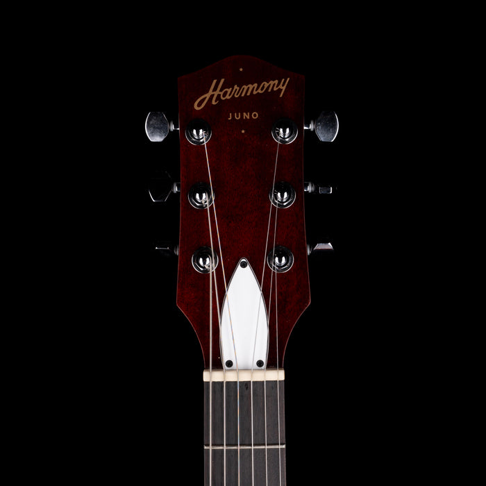 Guitar headstock with 'Harmony' branding on a black background