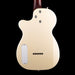 Back view of a cream-colored electric guitar on a black background
