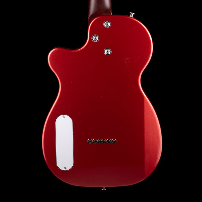 Red electric guitar body with a black background