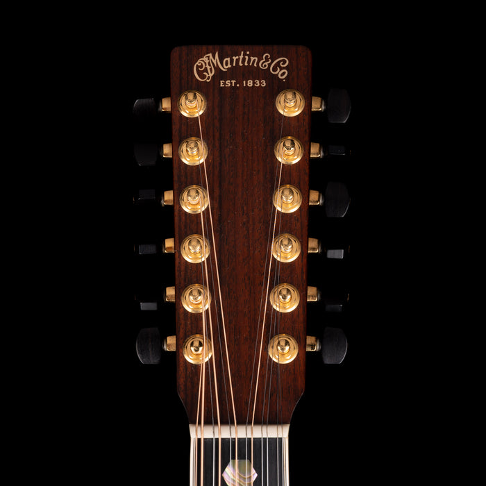 Close-up of a Martin guitar headstock with brand name and establishment year on a black background