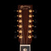 Close-up of a Martin guitar headstock with brand name and establishment year on a black background