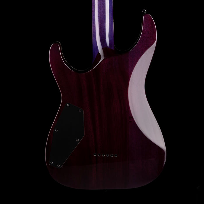Purple electric guitar with a black pickguard on a black background